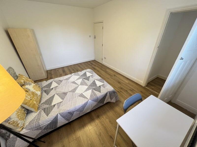 Bright and tidy double bedroom featuring a comf...