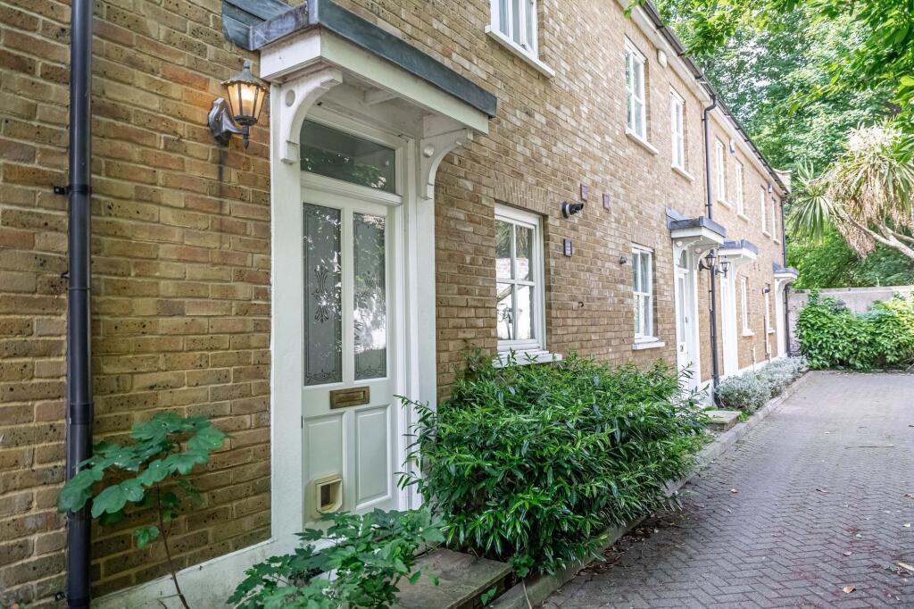 Well-maintained terraced house exterior with ne...