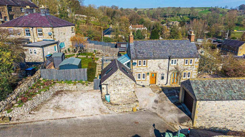 Aerial overview of house, garden and parking