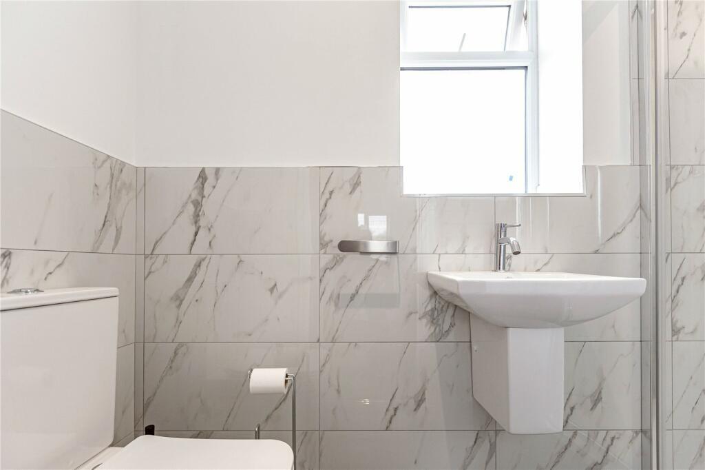 A bright and clean bathroom featuring modern wh...