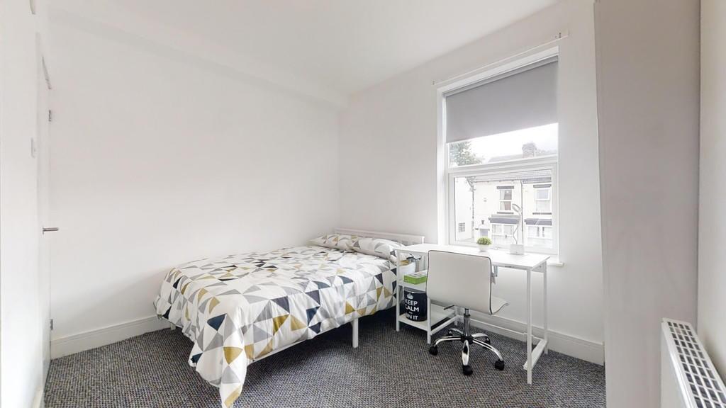 A bright and tidy single bedroom featuring a co...