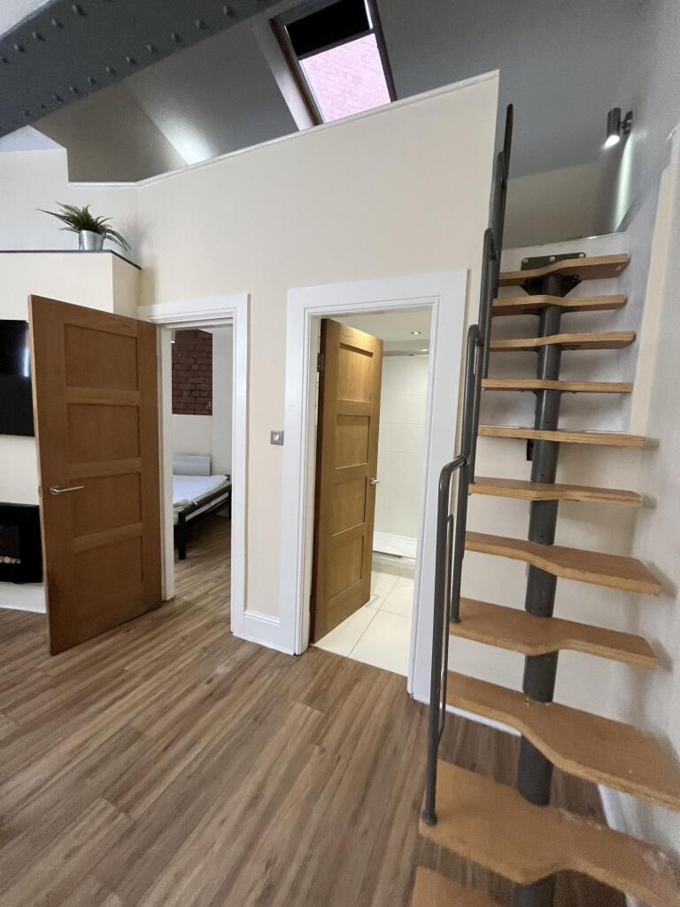 Bright and modern room featuring a sleek wooden...