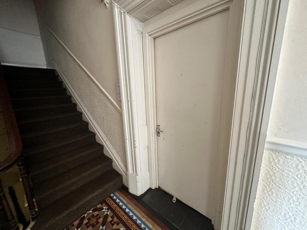 A well-maintained hallway with charming archite...