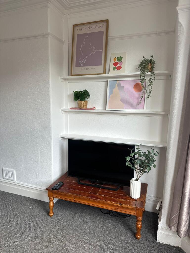 A cozy and well-maintained living room featurin...