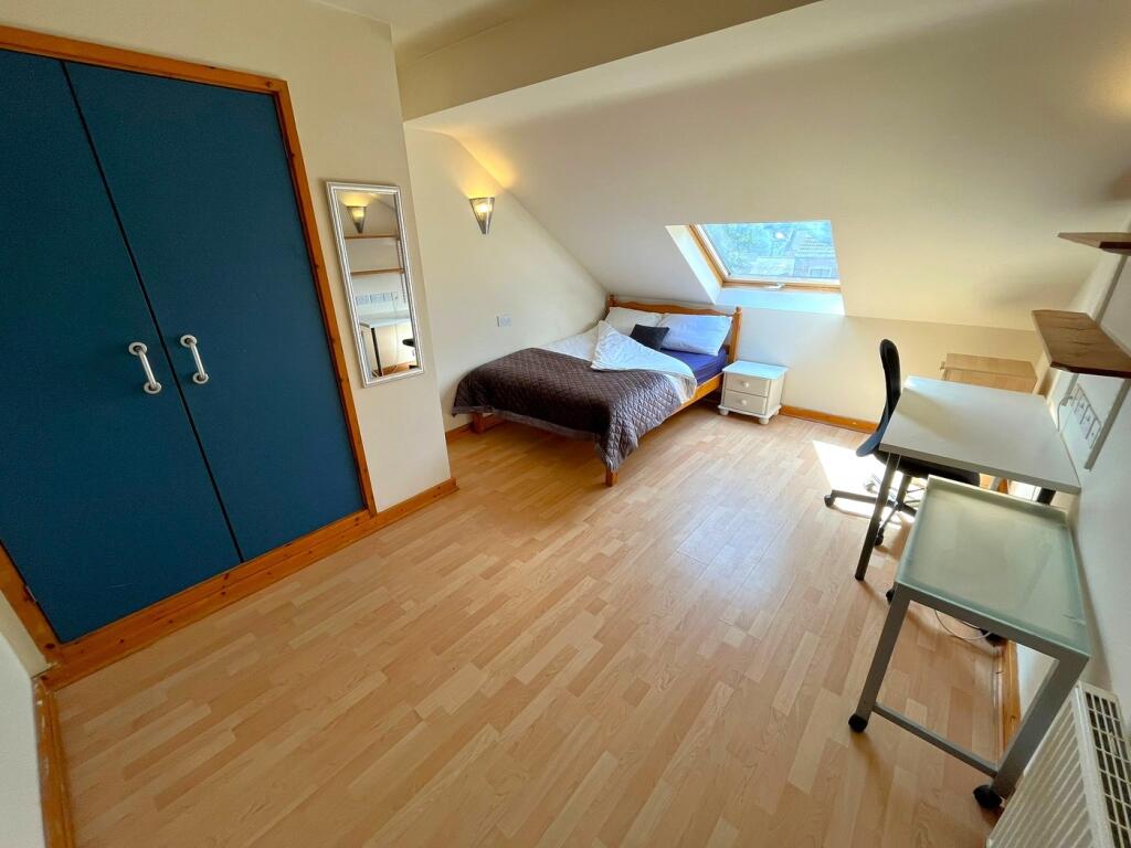 A bright and spacious double bedroom featuring ...