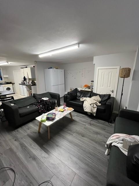 Contemporary communal lounge with multiple sofa...