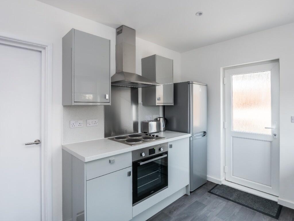 Bright and modern kitchen with sleek grey cabin...