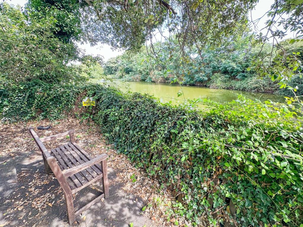 OUTSIDE REAR - COMMUNAL GROUNDS &amp; LAKE