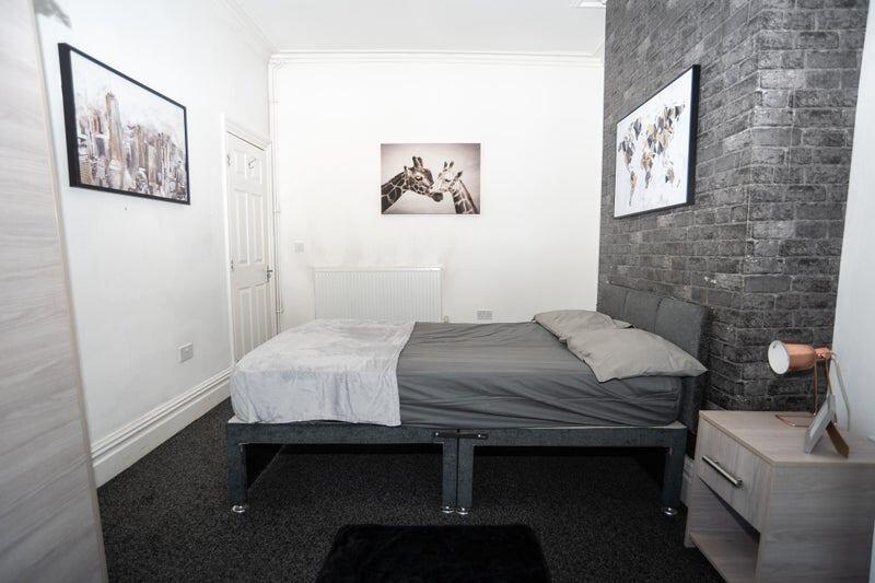 A clean and modern double bedroom featuring a c...
