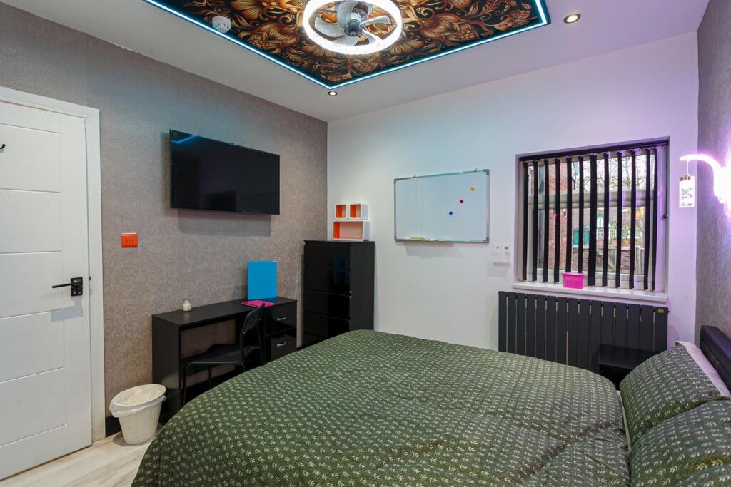 A stylish double bedroom with modern decor, per...