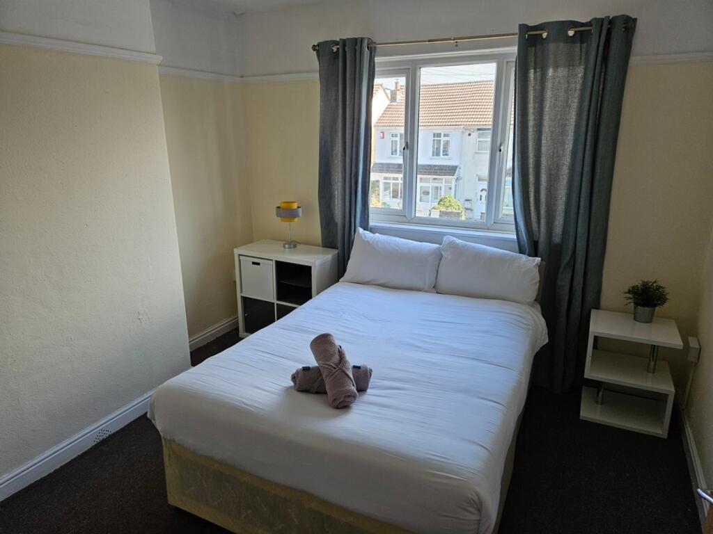 A bright and inviting double bedroom with ample...