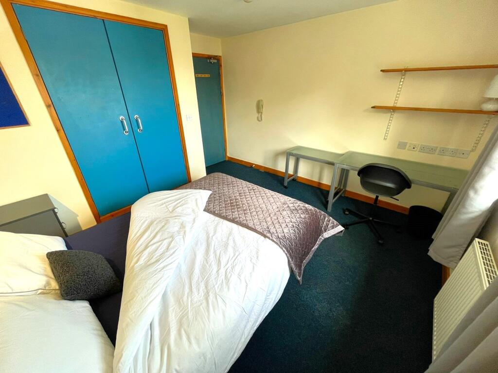 A cozy double bedroom featuring practical furni...