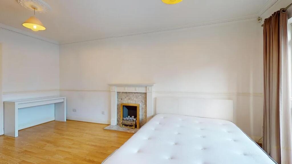 Bright and spacious master bedroom featuring a ...