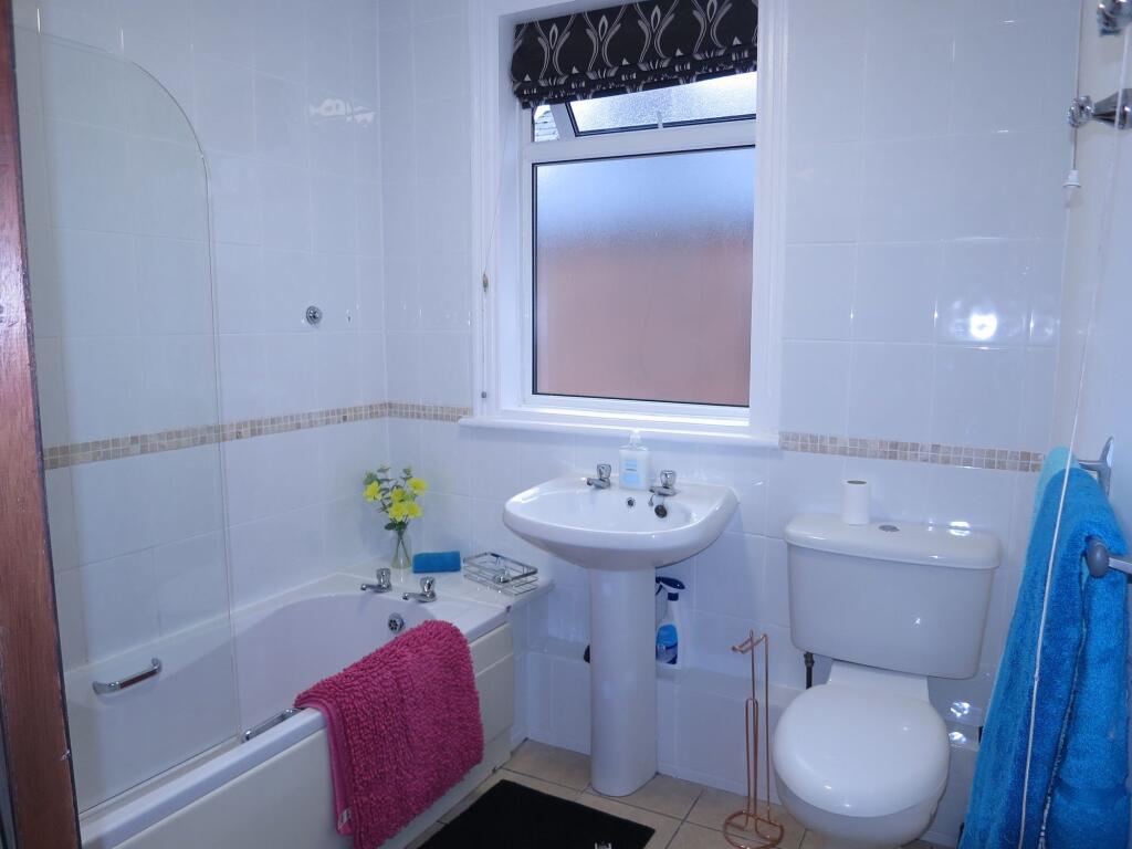 Bright and functional bathroom featuring a bath...