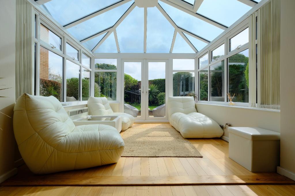 Sun filled conservatory, doors to garden