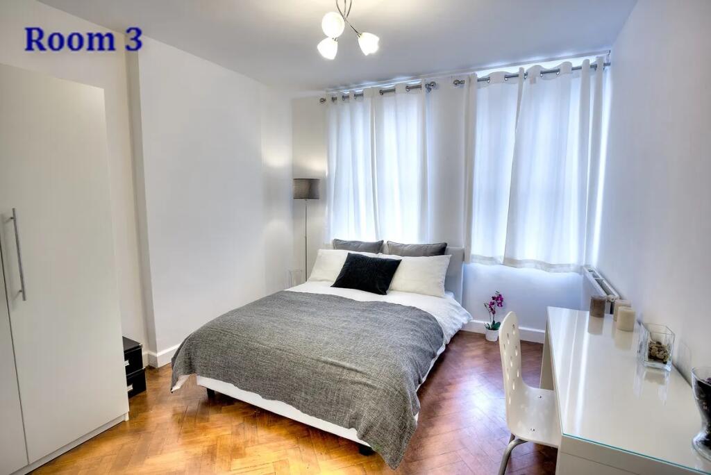 Bright and modern double bedroom featuring a co...