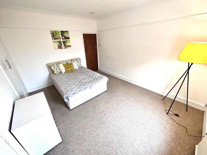 A bright and tidy double bedroom featuring a co...