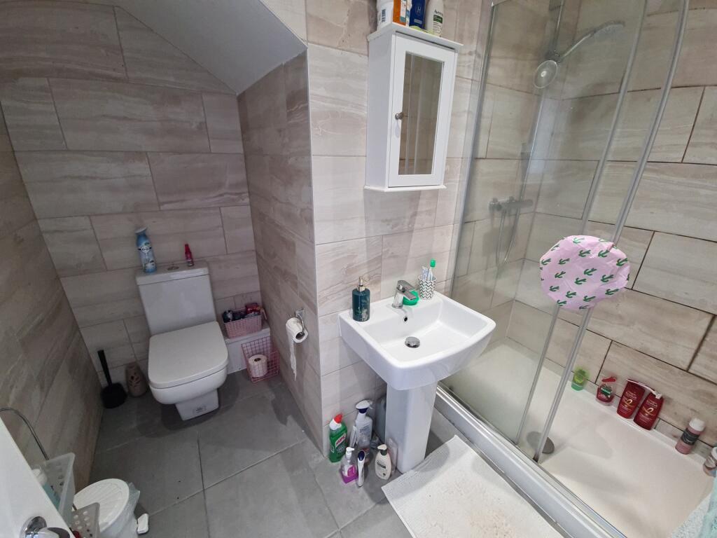 A clean and modern bathroom featuring a glass-e...
