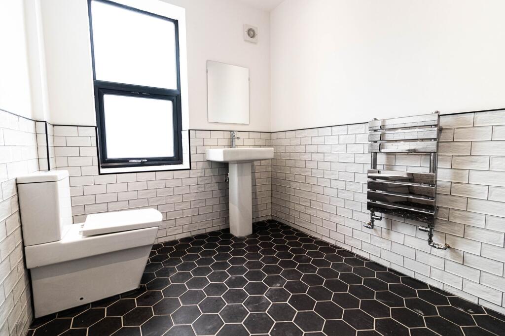 Bright, modern bathroom with contemporary white...