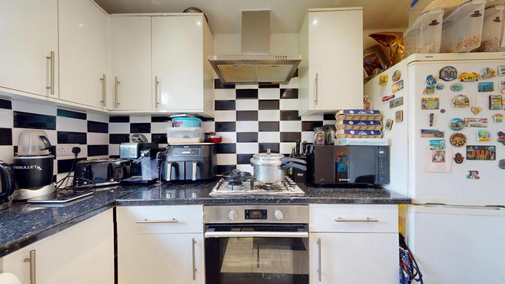 A well-equipped kitchen featuring modern applia...