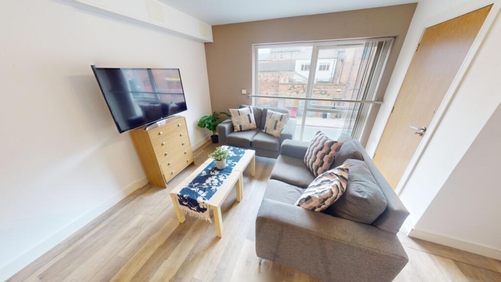Bright and modern living room featuring a comfo...
