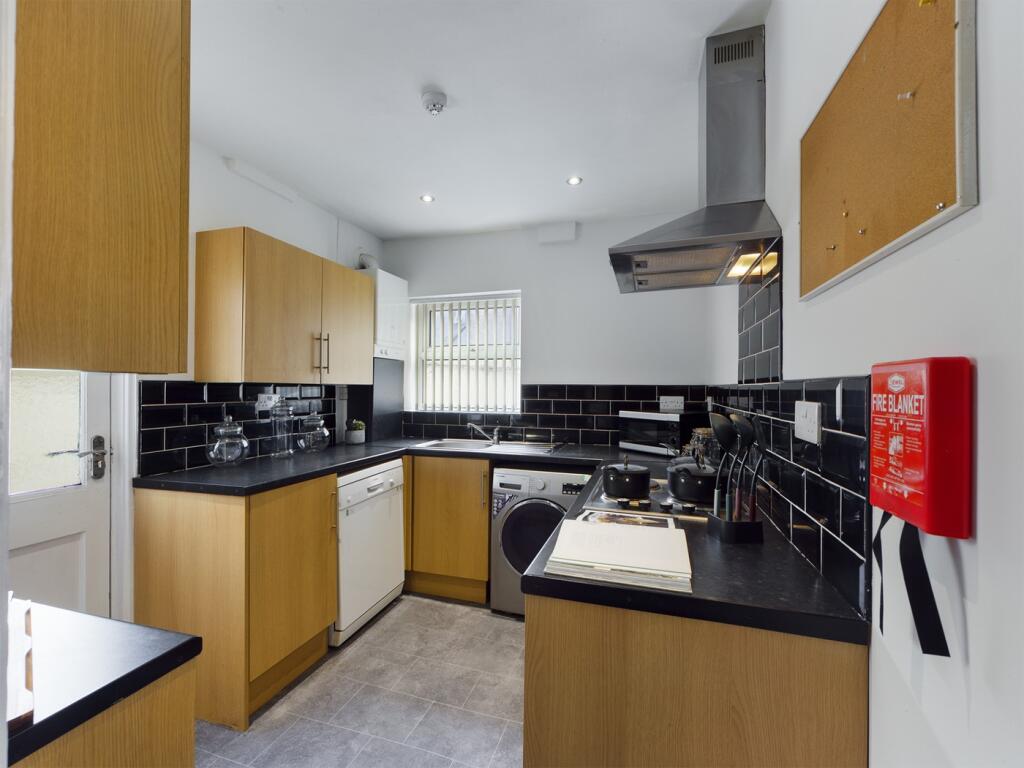 A modern and tidy kitchen featuring ample stora...