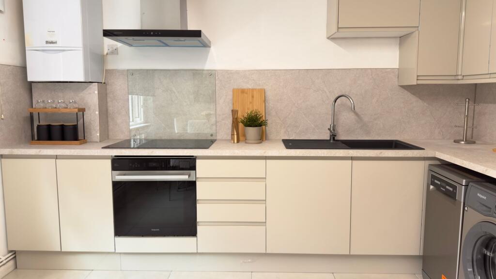 Modern, well-maintained kitchen featuring a sle...