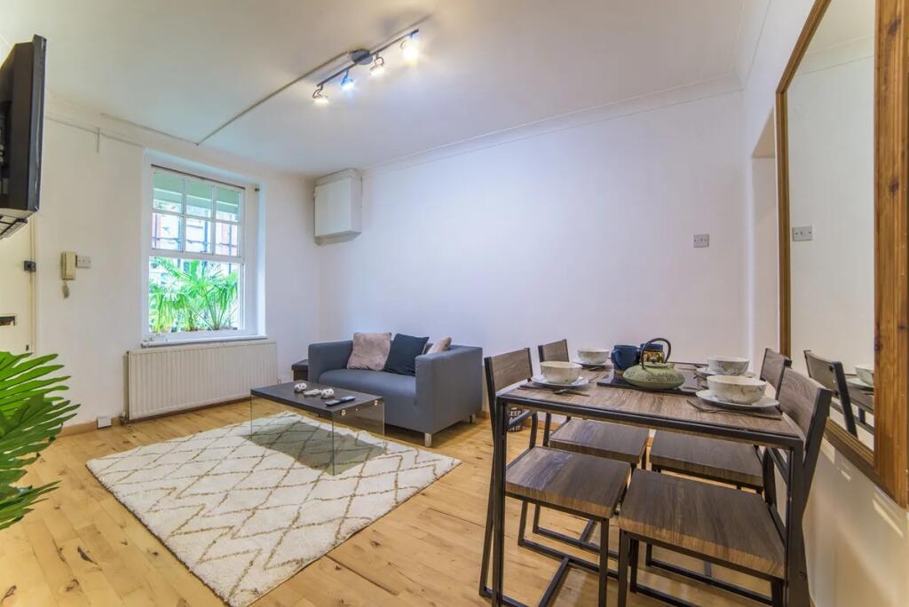 Bright and modern living room featuring a cozy ...