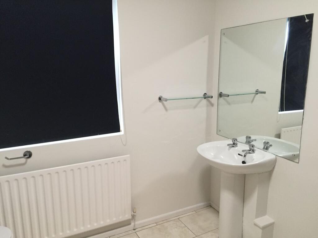 A clean, well-maintained bathroom featuring a p...