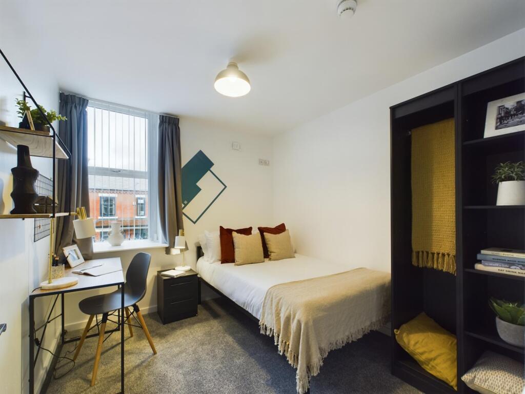 A bright and inviting double bedroom featuring ...