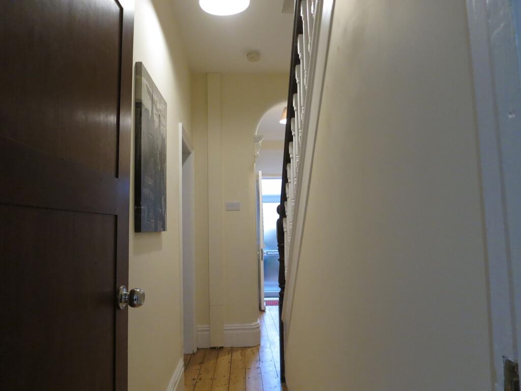 A well-maintained hallway with a classic wooden...