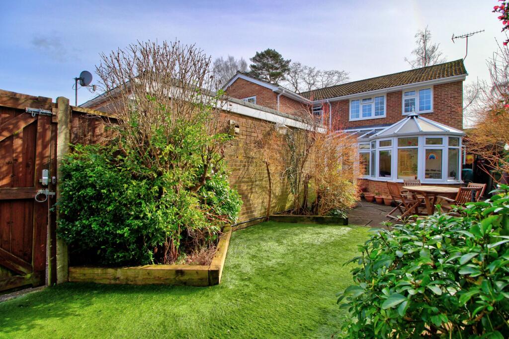 Enclosed garden with side gate to driveway