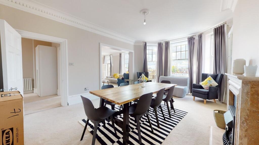 A bright and spacious living room featuring a l...