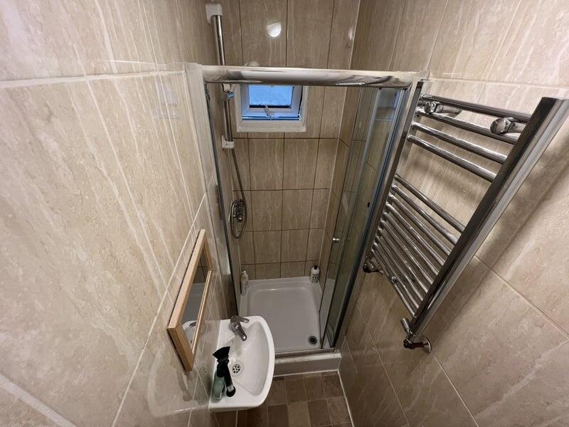 A well-maintained bathroom featuring beige tile...