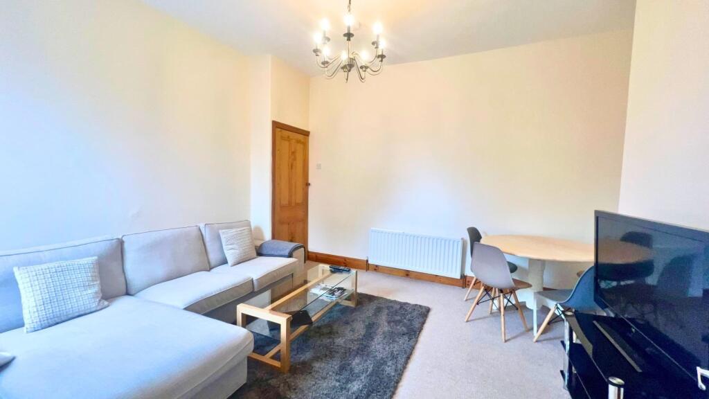 A bright and welcoming living room featuring a ...