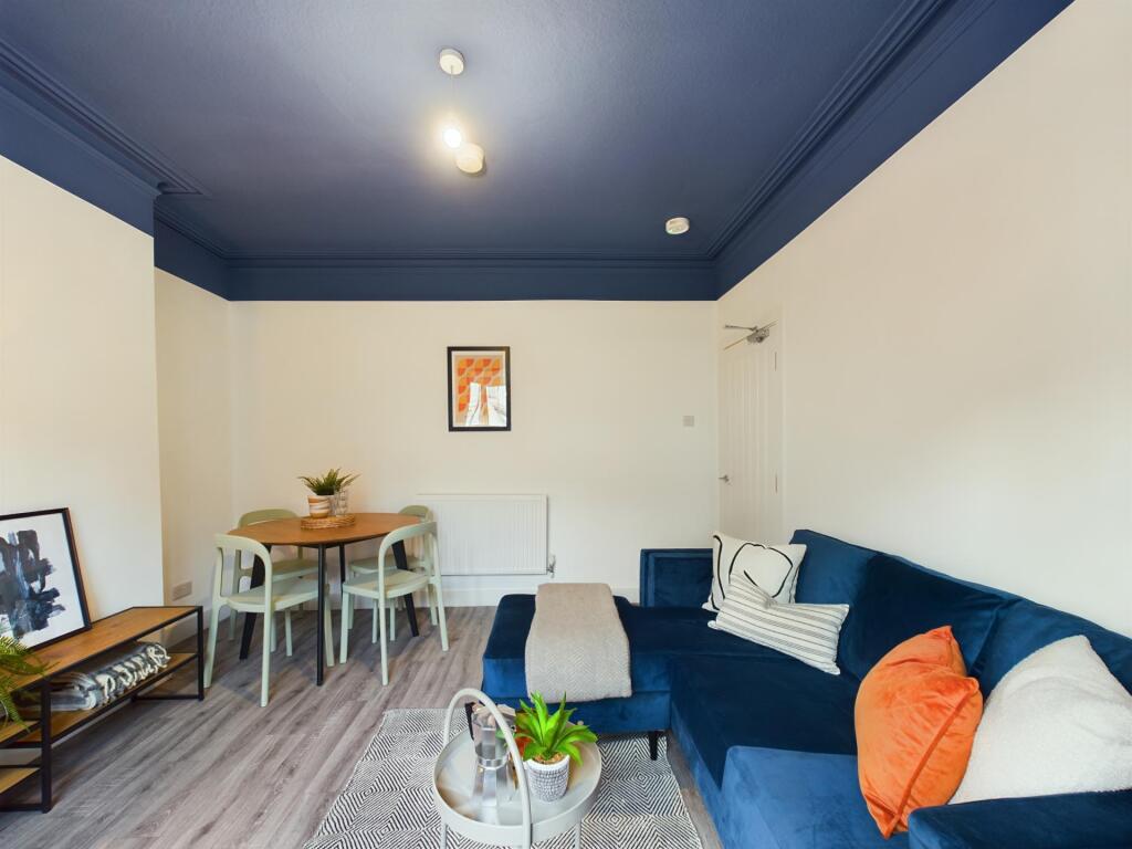 A spacious, contemporary living room with comfo...