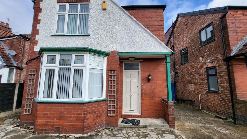 A charming view of a brick-fronted house with a...