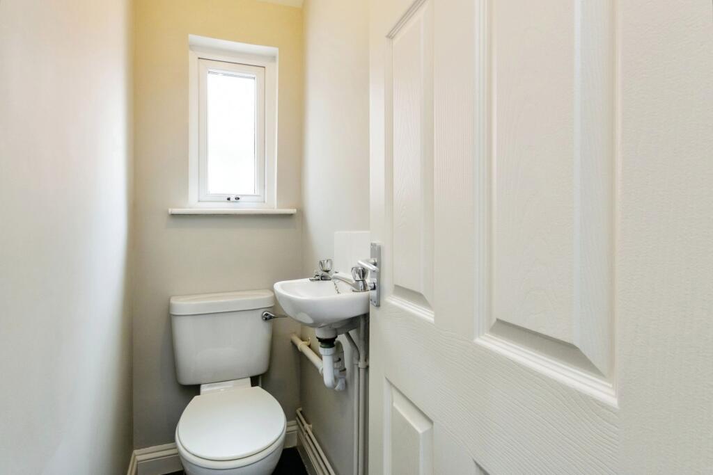 A compact, well-maintained bathroom featuring a...