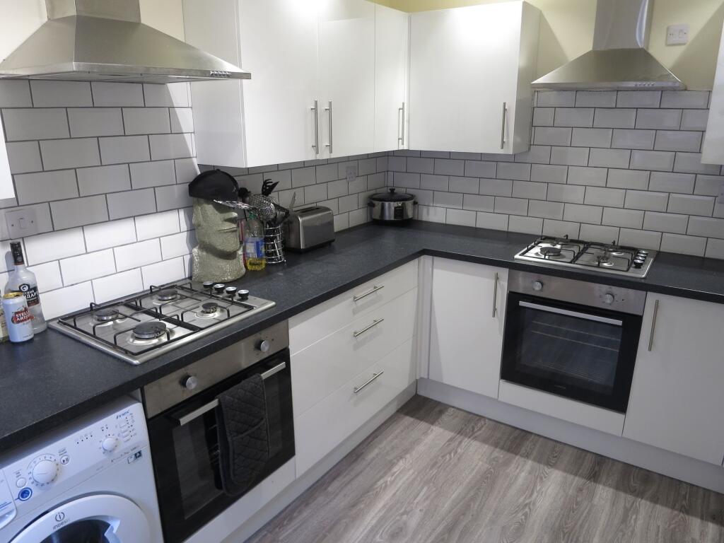 Modern and well-maintained kitchen with white c...