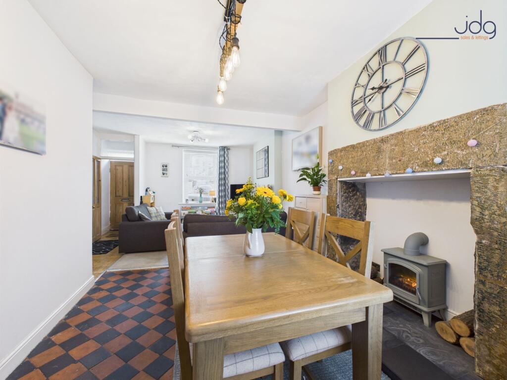 Spacious open-plan lounge diner and decorative fireplace with electric stove