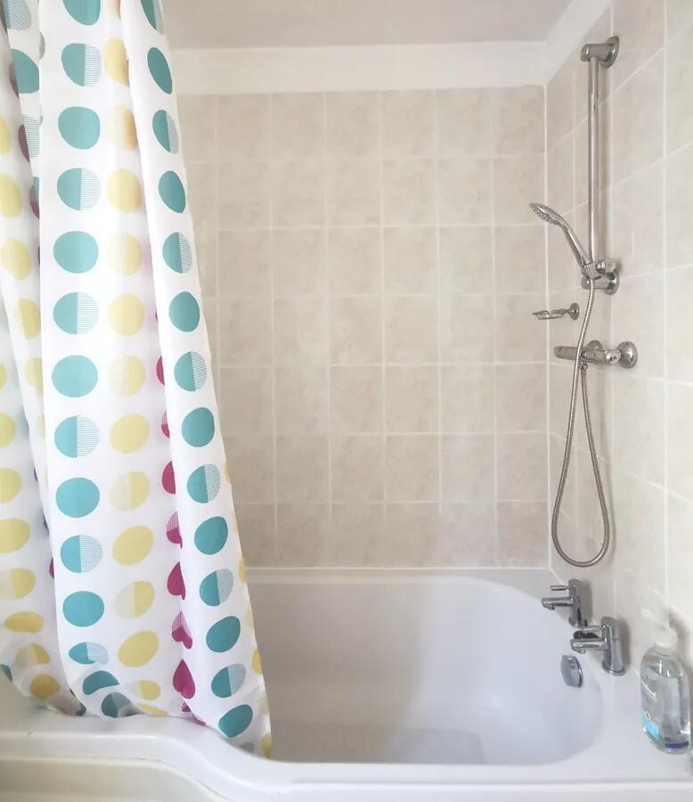Bright and tidy bathroom featuring a clean whit...