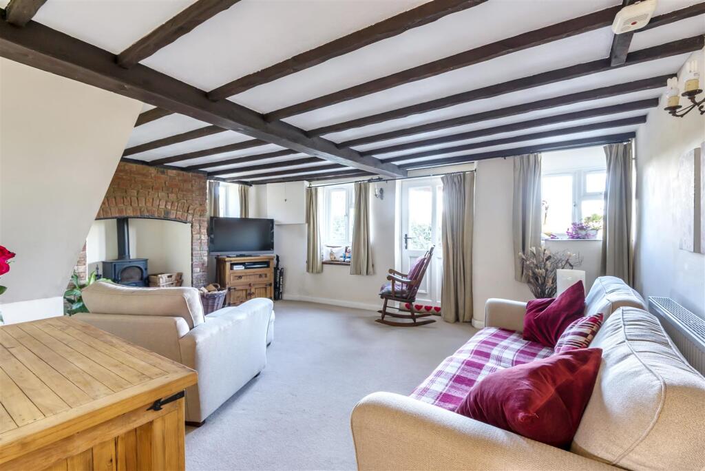 sitting room with exposed wooden beams