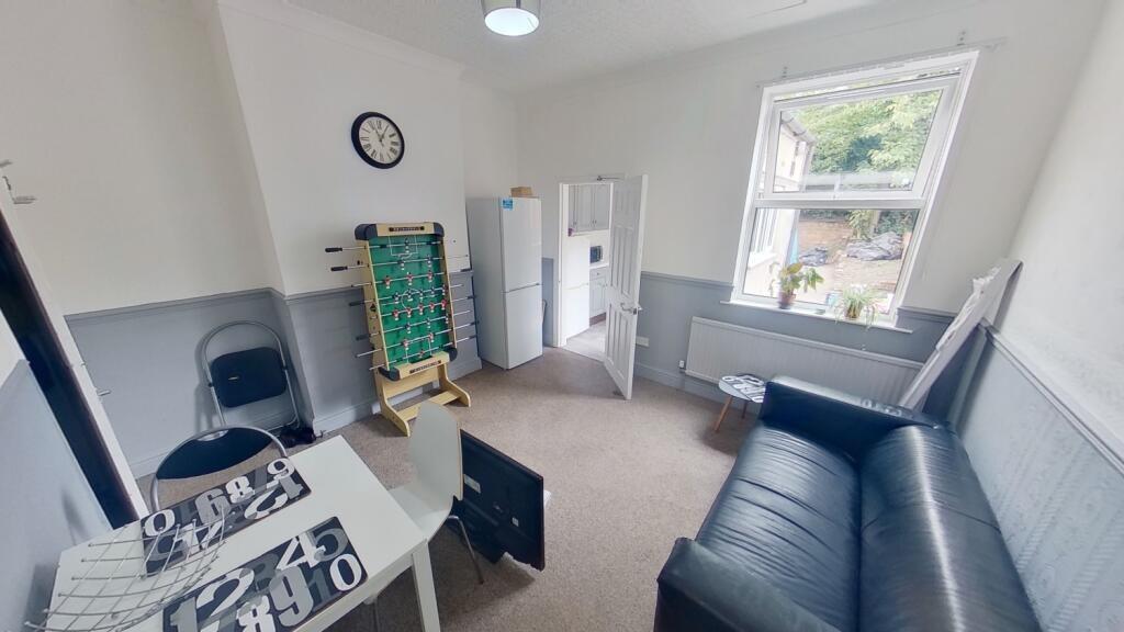 A clean and well-lit small room featuring a sin...