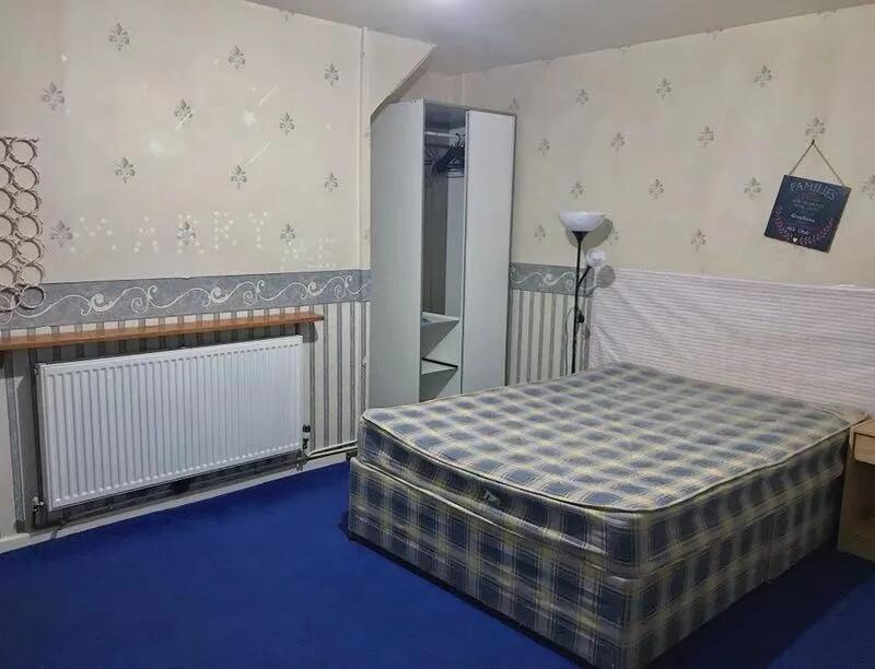 A cozy double bedroom featuring a plaid double ...