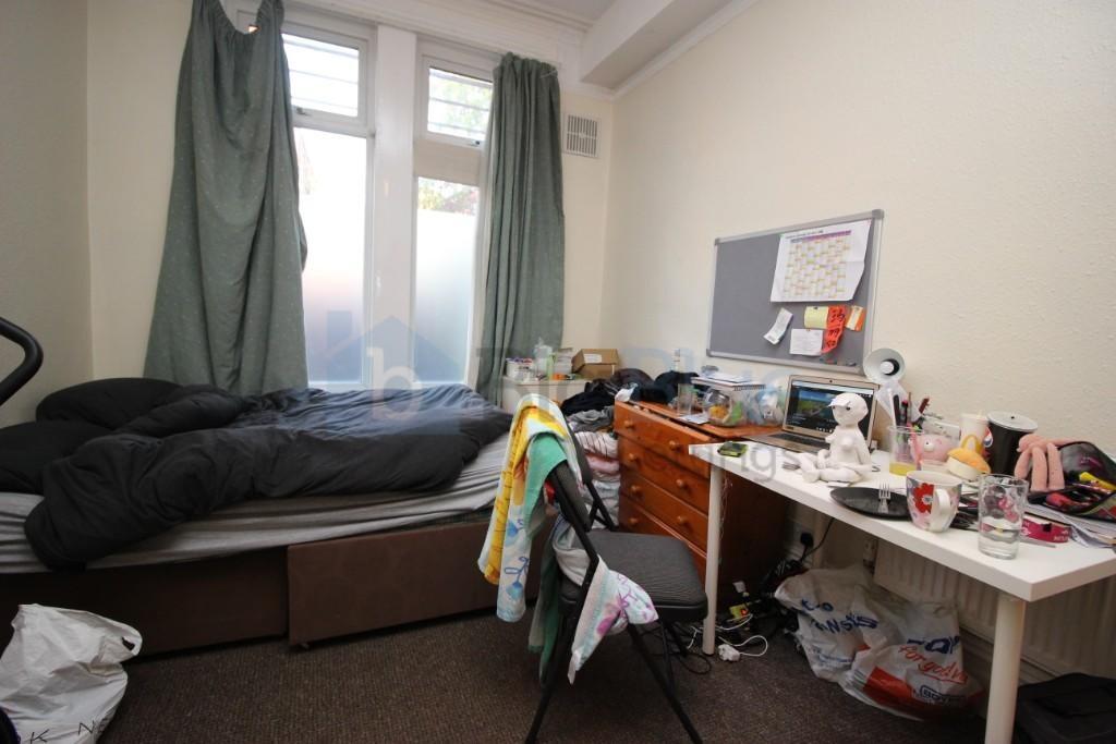 Cozy single bedroom featuring a comfortable bed...
