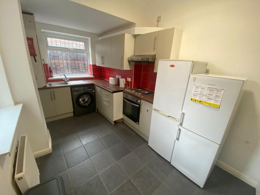 Bright and functional kitchen with modern appli...