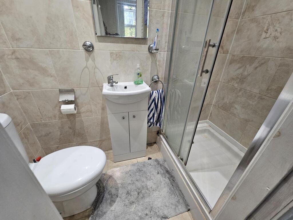 A clean and well-maintained bathroom with a sho...