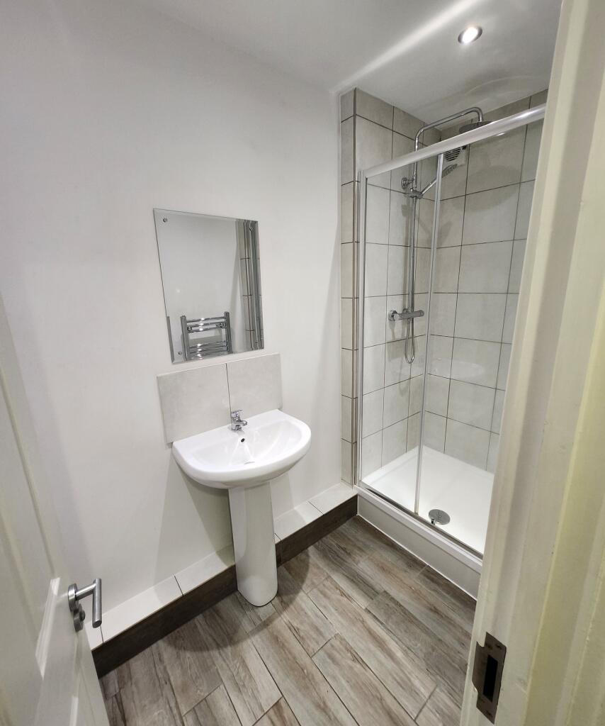 A clean and modern bathroom with a white pedest...