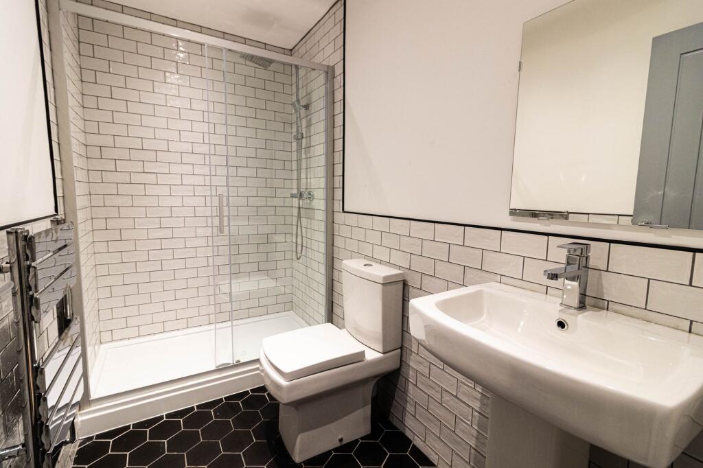 A modern and clean bathroom featuring a white t...