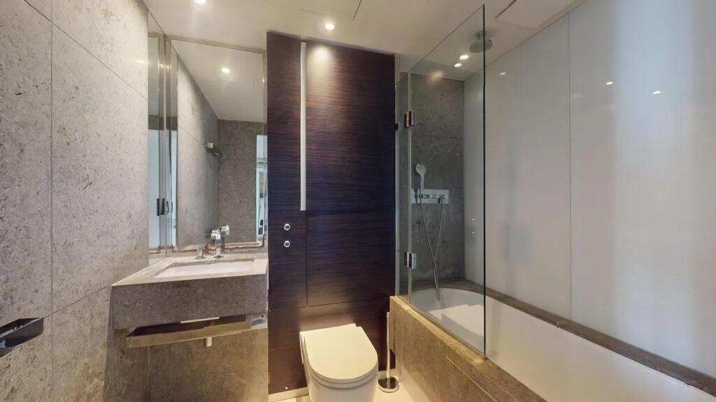 Modern bathroom suite featuring sleek stone fin...